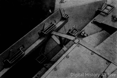 A downwards and oblique view of a part of the armor skirt. The brackets and hangers are clearly visible. The brackets allow the skirts to be hung at difference distances from the tank, to accomodate for the different widths of the summer and winter tracks.